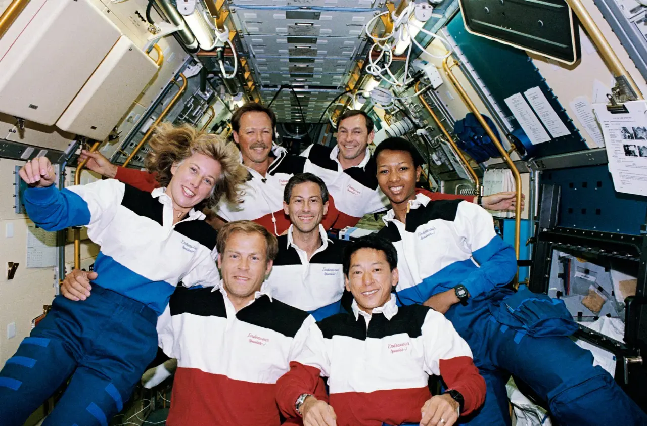 The seven crew members of STS-47 floating together in the Spacelab-J module aboard the space shuttle Endeavour, including mission specialist Mae Jemison.