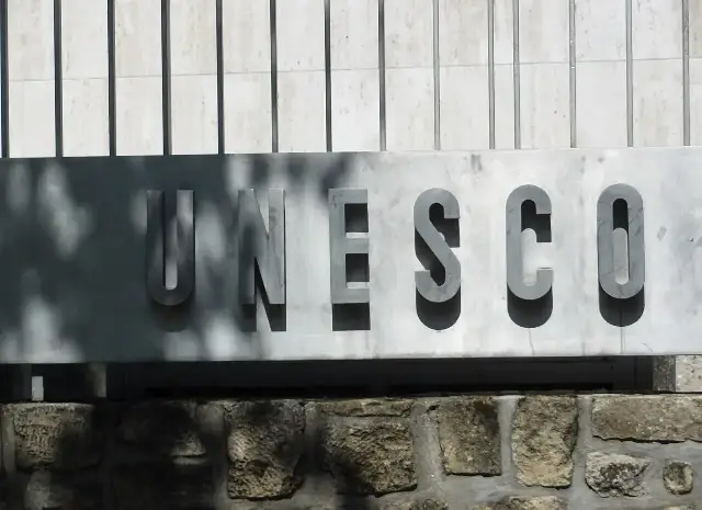 The UNESCO nameplate on the wall of its headquarters in Paris — a modern illustration of the organization founded by the 1945 constitution, not the signing itself.