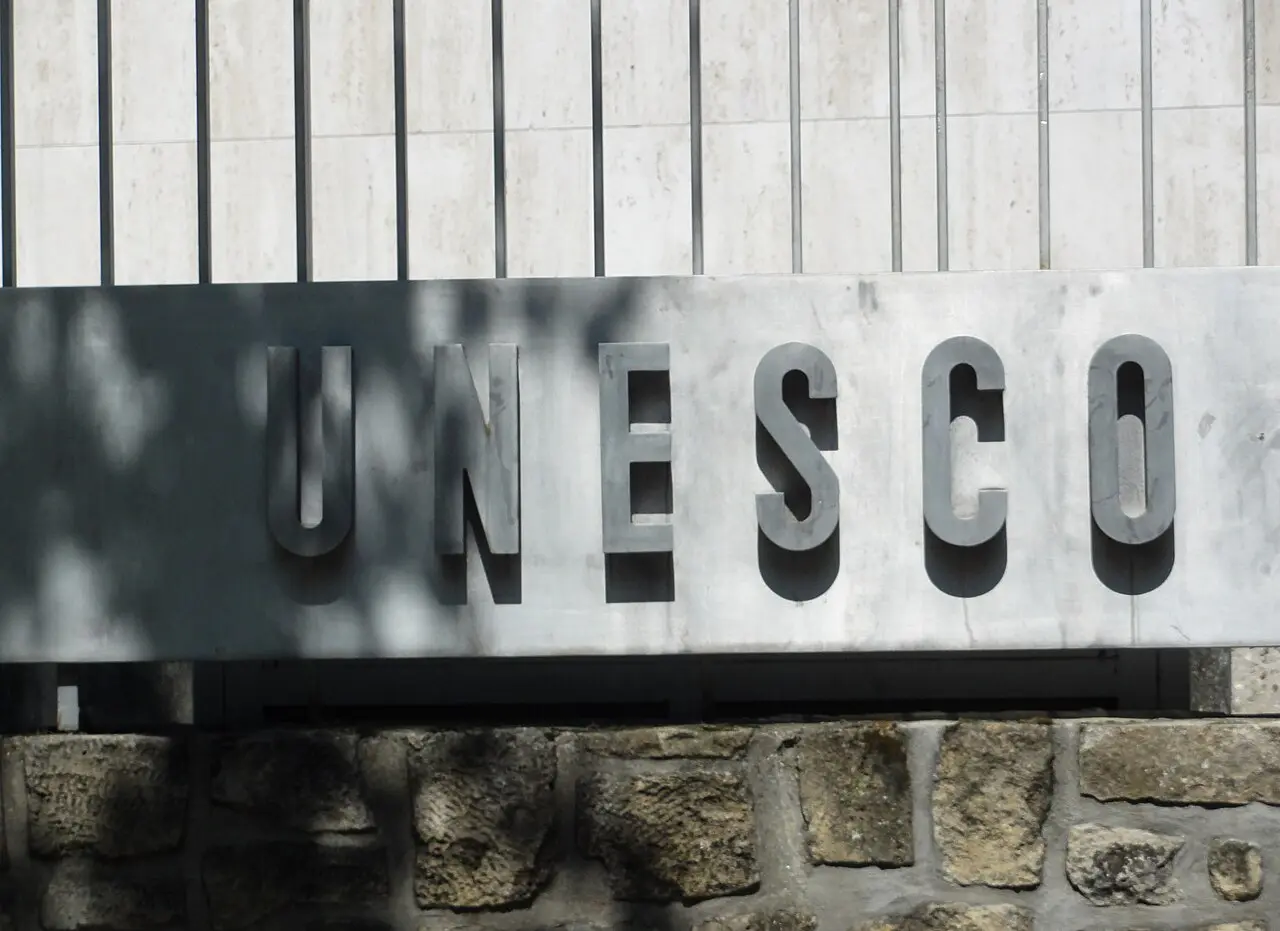 The UNESCO nameplate on the wall of its headquarters in Paris — a modern illustration of the organization founded by the 1945 constitution, not the signing itself.