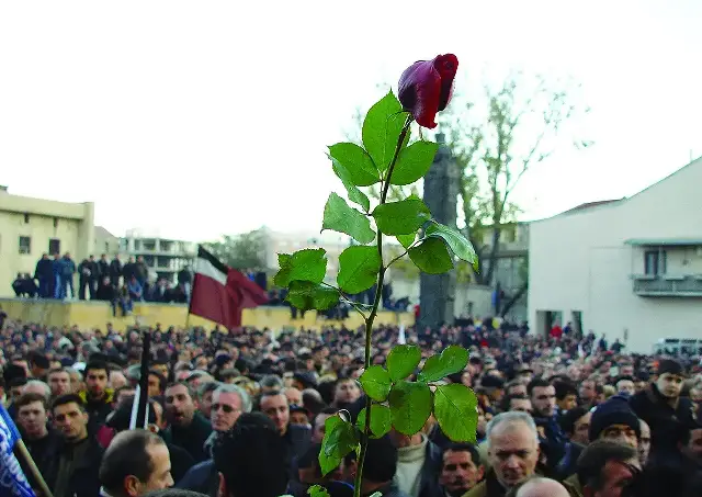 A red rose held aloft above a crowd of demonstrators in Tbilisi during Georgia's 2003 Rose Revolution.