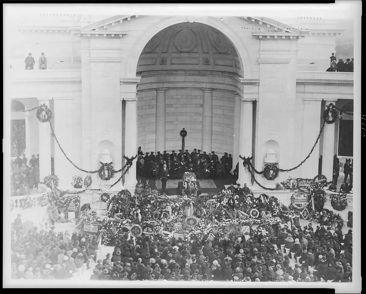 The state funeral for the Unknown Soldier at Arlington National Cemetery's Memorial Amphitheater on November 11, 1921, before a crowd of mourners.