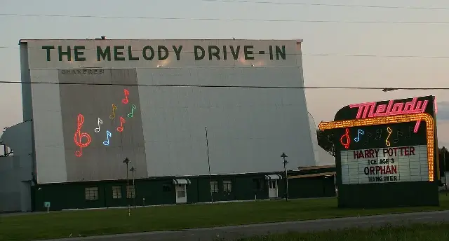 The Melody Drive-In theater in Ohio, with its large outdoor screen and neon-lit marquee.