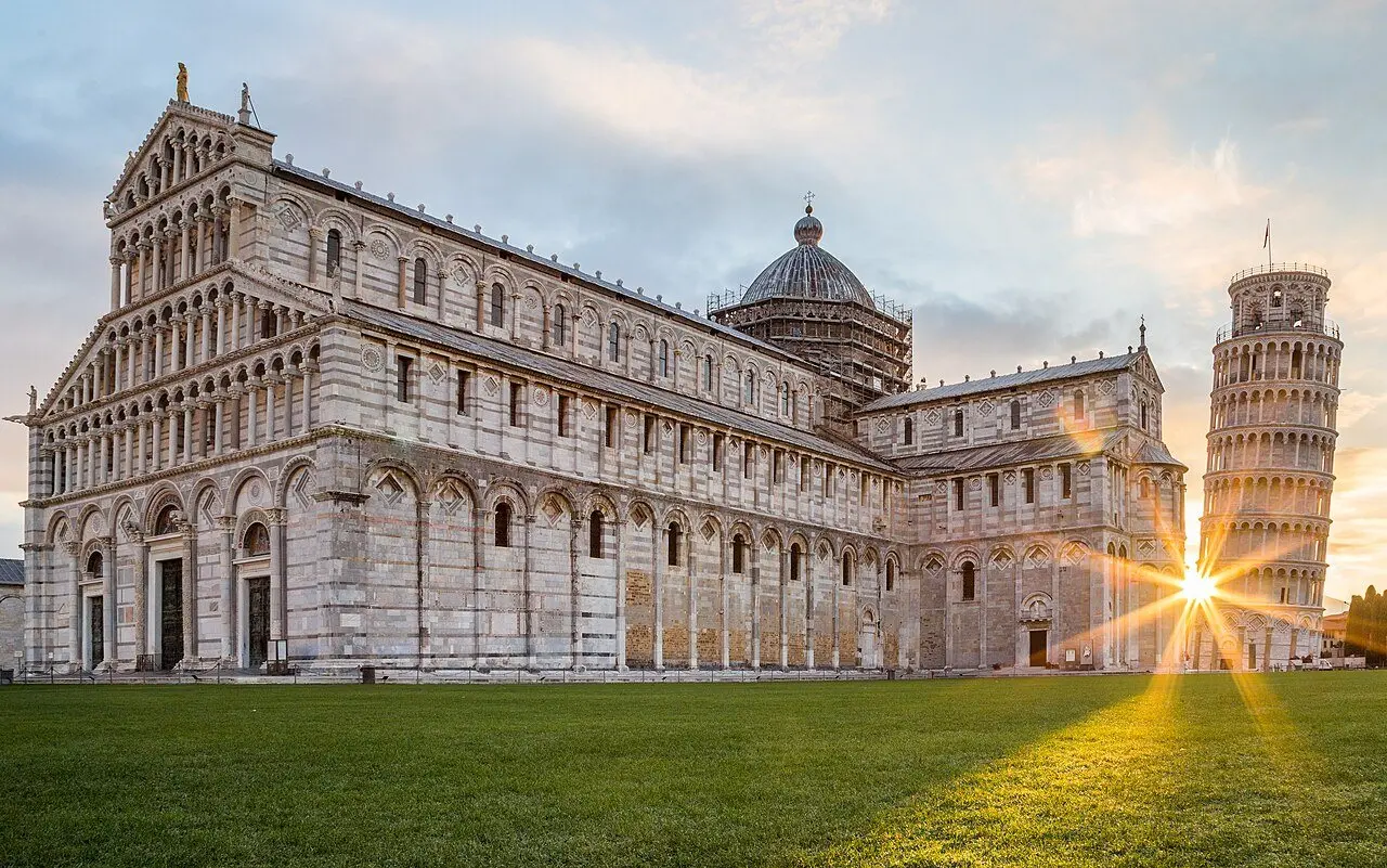 The Leaning Tower of Pisa and the Pisa Cathedral at sunrise in the Piazza dei Miracoli.