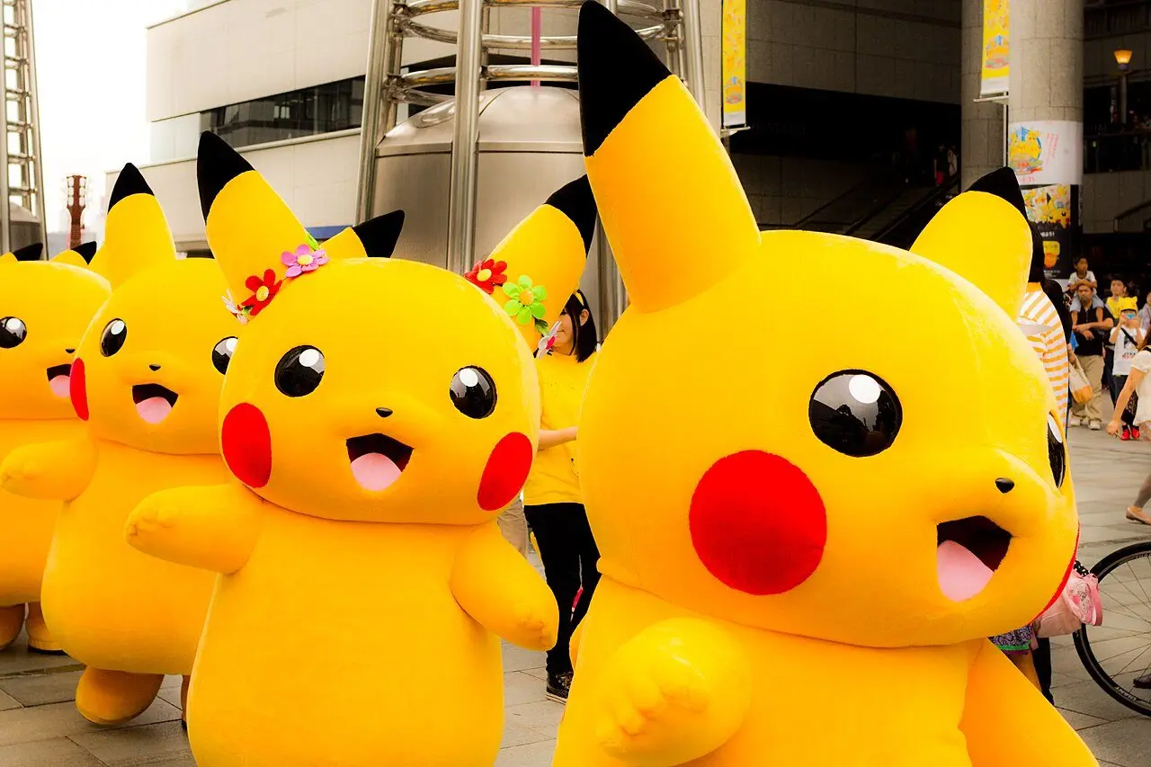 Pikachu costumed characters parading through a city street
