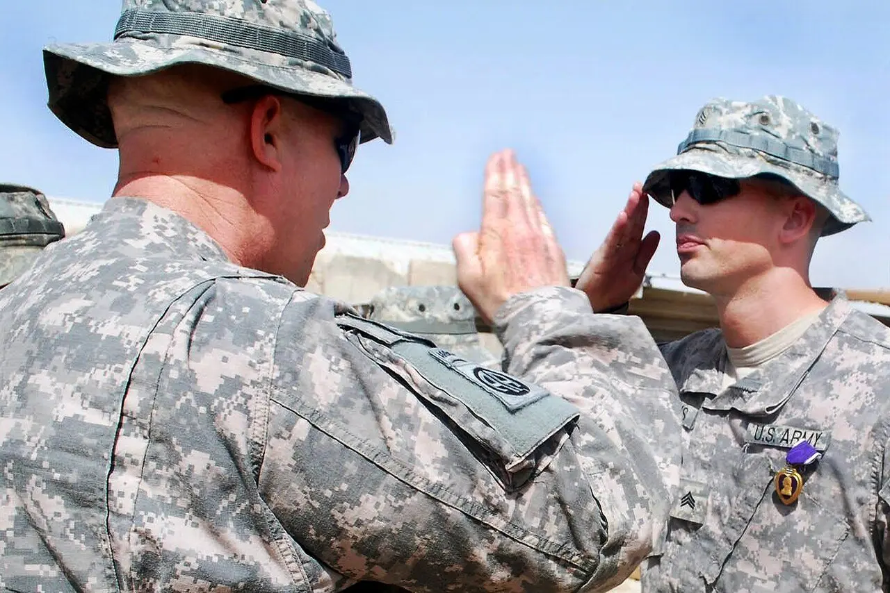 A U.S. Army colonel presents the Purple Heart medal to Sgt. Ryan Higgins during a 2009 award ceremony in Iraq.