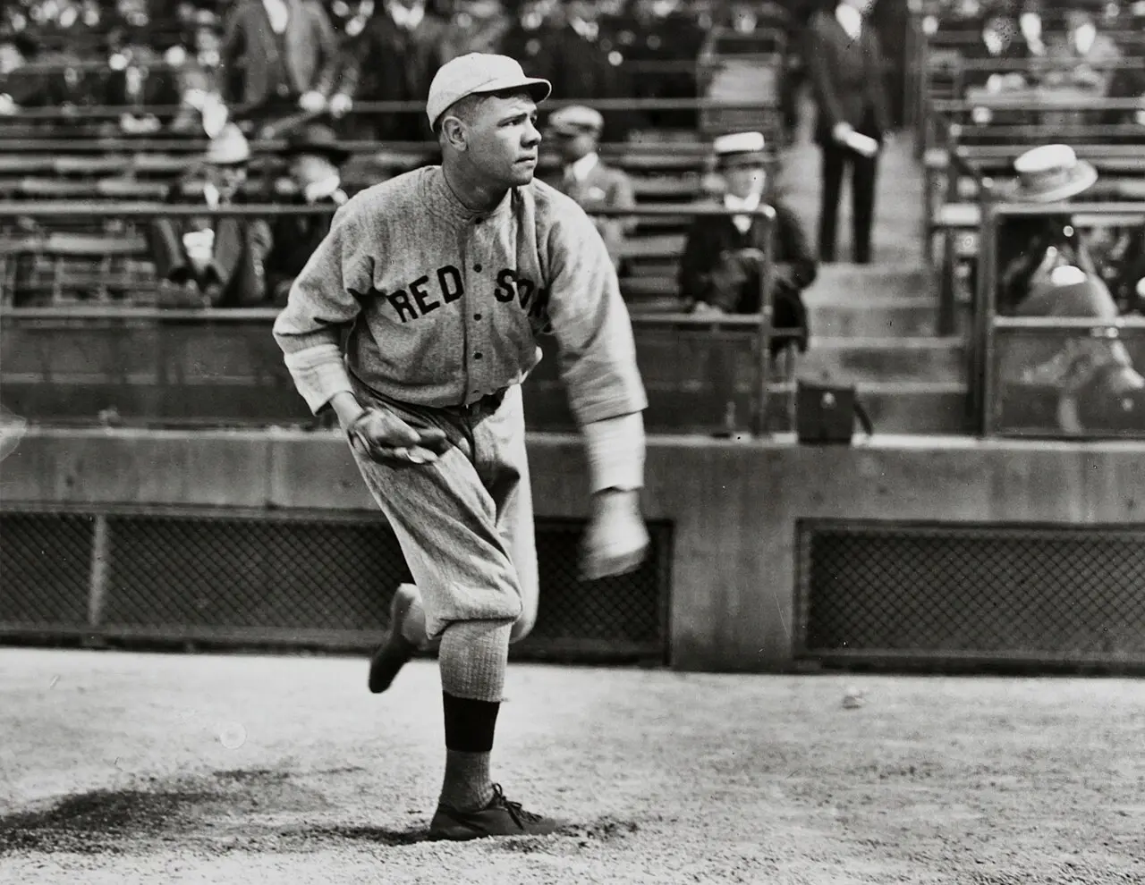 A young Babe Ruth pitching in a Boston Red Sox uniform