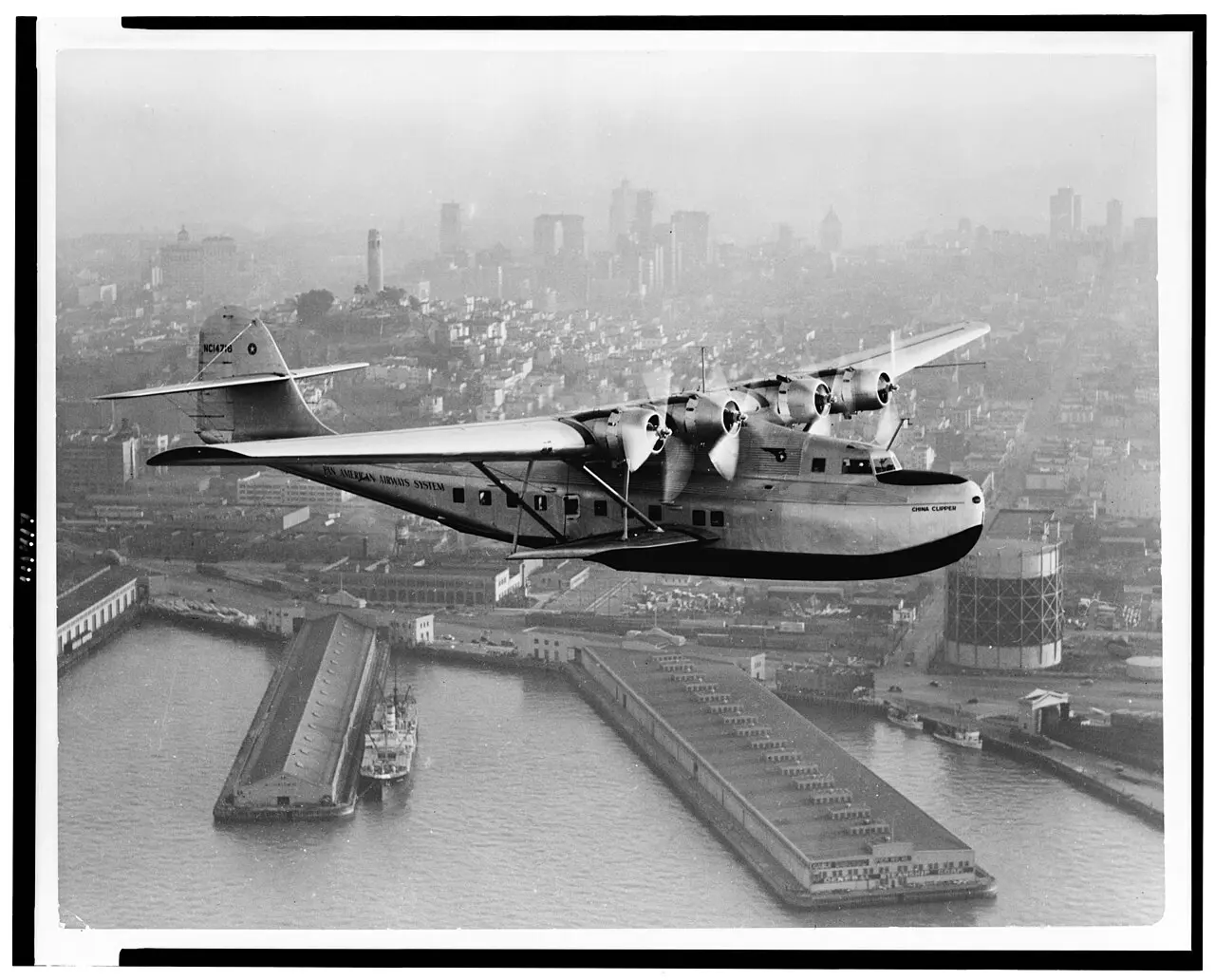 A period photograph of Pan Am's Martin M-130 flying boat China Clipper in flight over San Francisco.