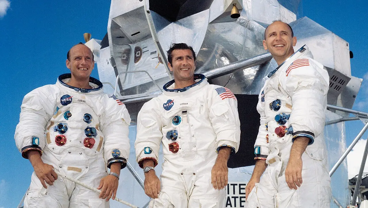 NASA portrait of the Apollo 12 crew — Charles 'Pete' Conrad, Richard Gordon and Alan Bean — in spacesuits before their lunar module; illustrative of the mission's crew.