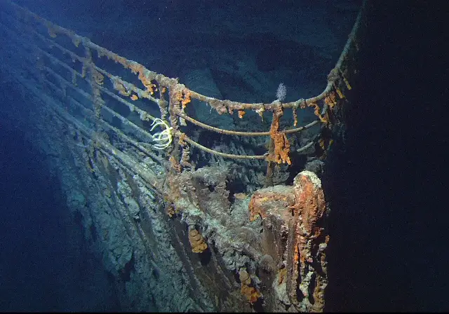 The rusted bow railing of the Titanic wreck, photographed by a remotely operated vehicle in the deep Atlantic.
