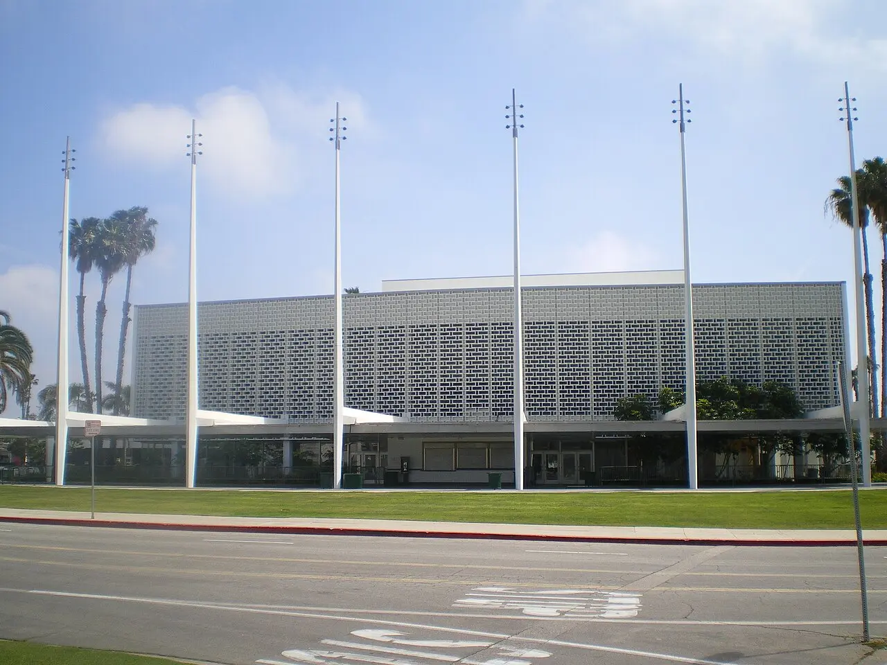 Exterior of the Santa Monica Civic Auditorium on a sunny day — the venue that hosted the 36th Academy Awards in 1964, shown as an illustration