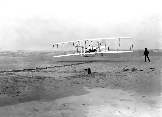 The Wright Flyer lifting off at Kitty Hawk, North Carolina, on December 17, 1903, in John T. Daniels's famous photograph.