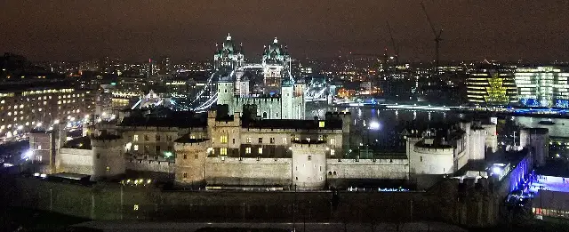 A modern nighttime photograph of the Tower of London, where Perkin Warbeck was imprisoned before his execution in 1499.