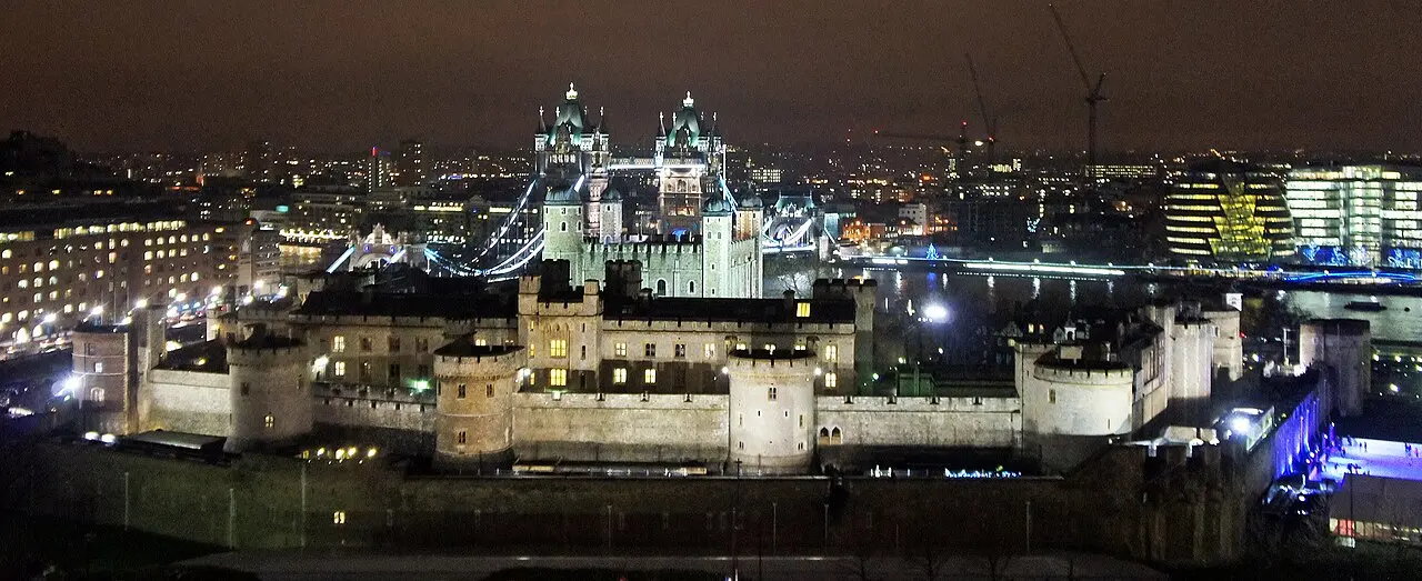 A modern nighttime photograph of the Tower of London, where Perkin Warbeck was imprisoned before his execution in 1499.