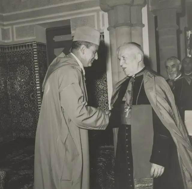 King Mohammed V of Morocco shaking hands with a Catholic bishop