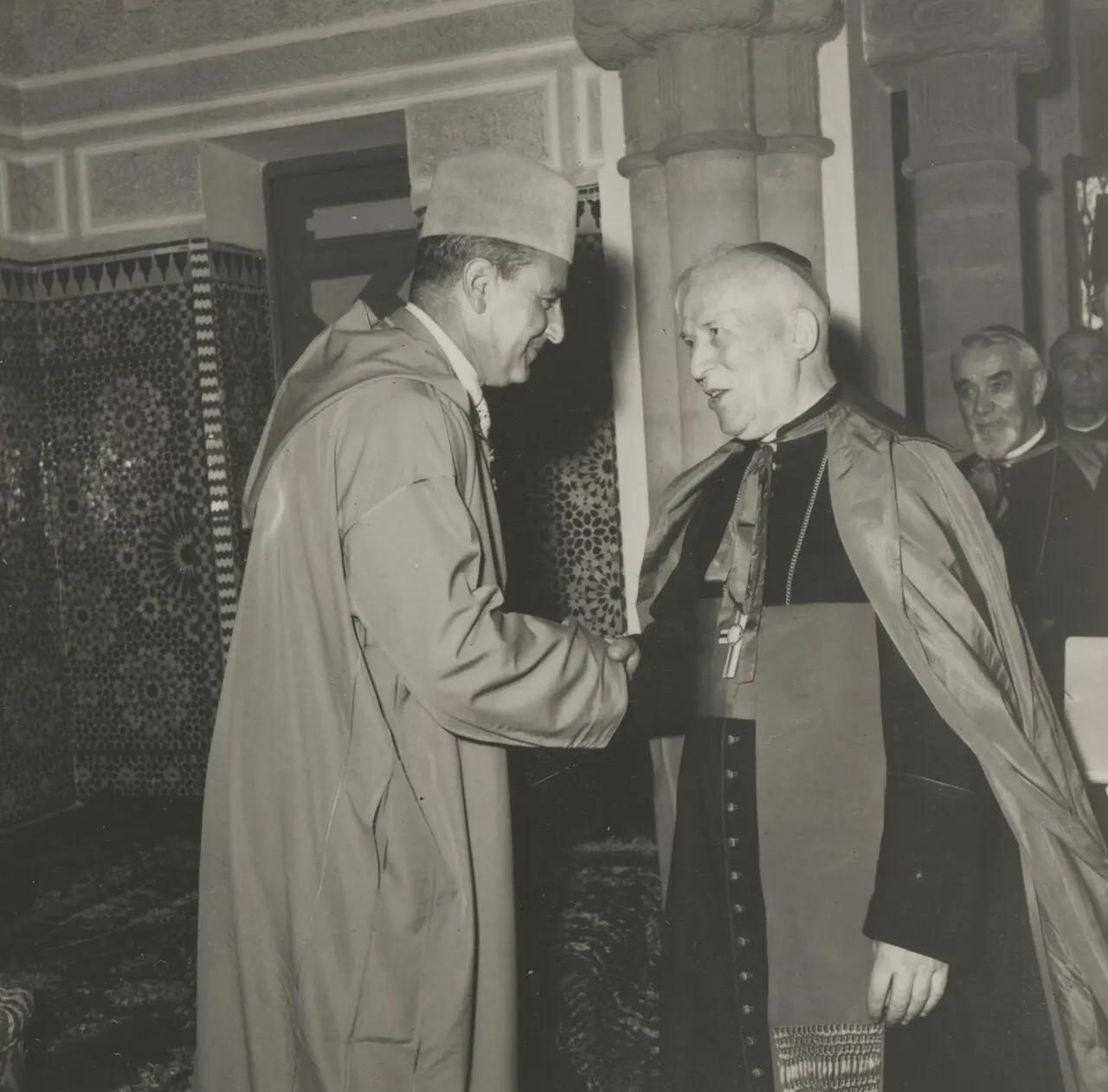 King Mohammed V of Morocco shaking hands with a Catholic bishop