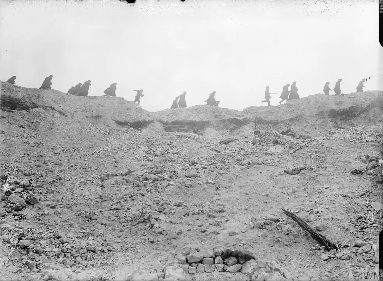 British troops moving along the lip of the Lochnagar mine crater in October 1916, during the Battle of the Somme — an illustration of the devastated battlefield, not the battle's final day.