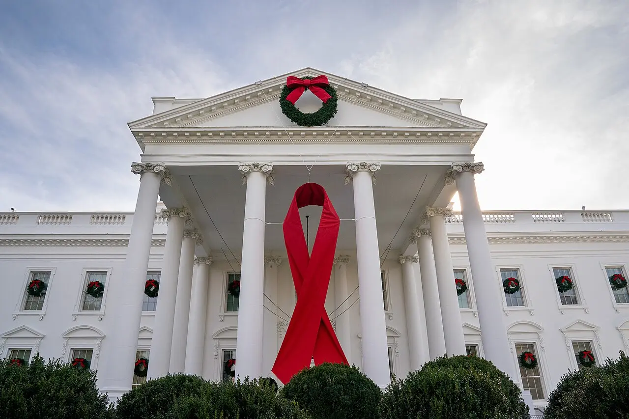 A giant red AIDS ribbon hanging from the White House portico for World AIDS Day.