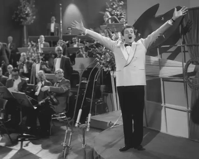 Domenico Modugno performing on stage in 1958, the year his song "Volare" won the first Grammy for Record of the Year