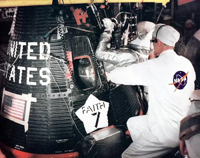 Astronaut Gordon Cooper in his silver pressure suit climbing into his Faith 7 Mercury capsule before launch, May 1963.