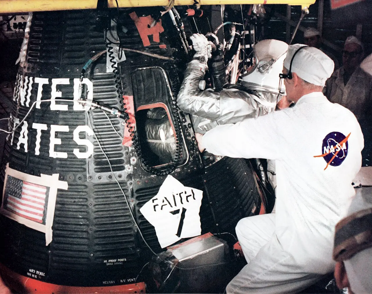 Astronaut Gordon Cooper in his silver pressure suit climbing into his Faith 7 Mercury capsule before launch, May 1963.