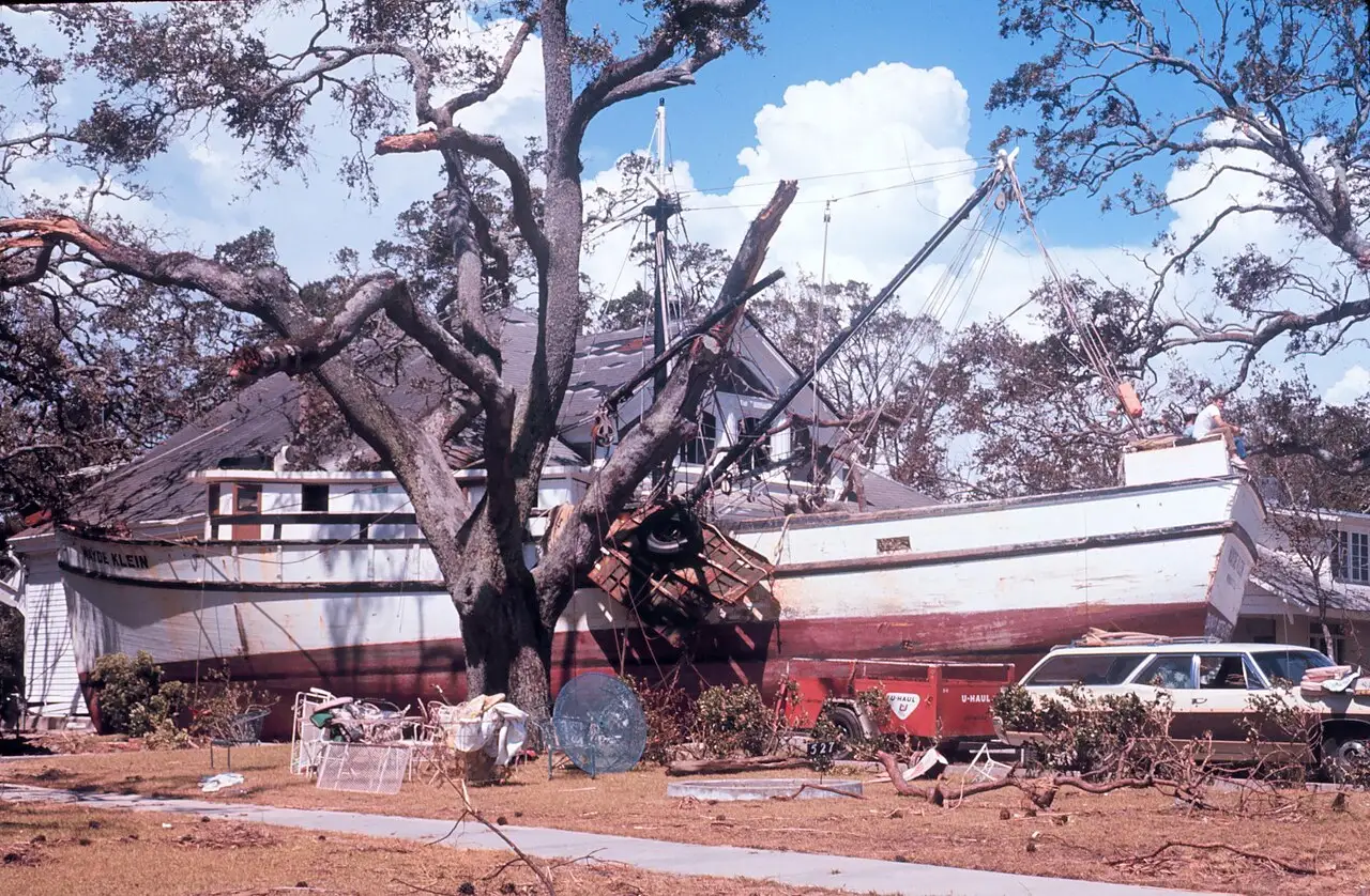 A fishing boat washed up against a house on the Mississippi Gulf Coast after Hurricane Camille, 1969.