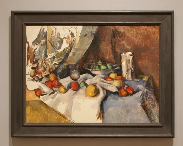 Paul Cézanne's 'Still Life with Apples' (1895–98), one of the works shown in MoMA's inaugural 1929 exhibition and later acquired by the museum, photographed on its gallery wall.