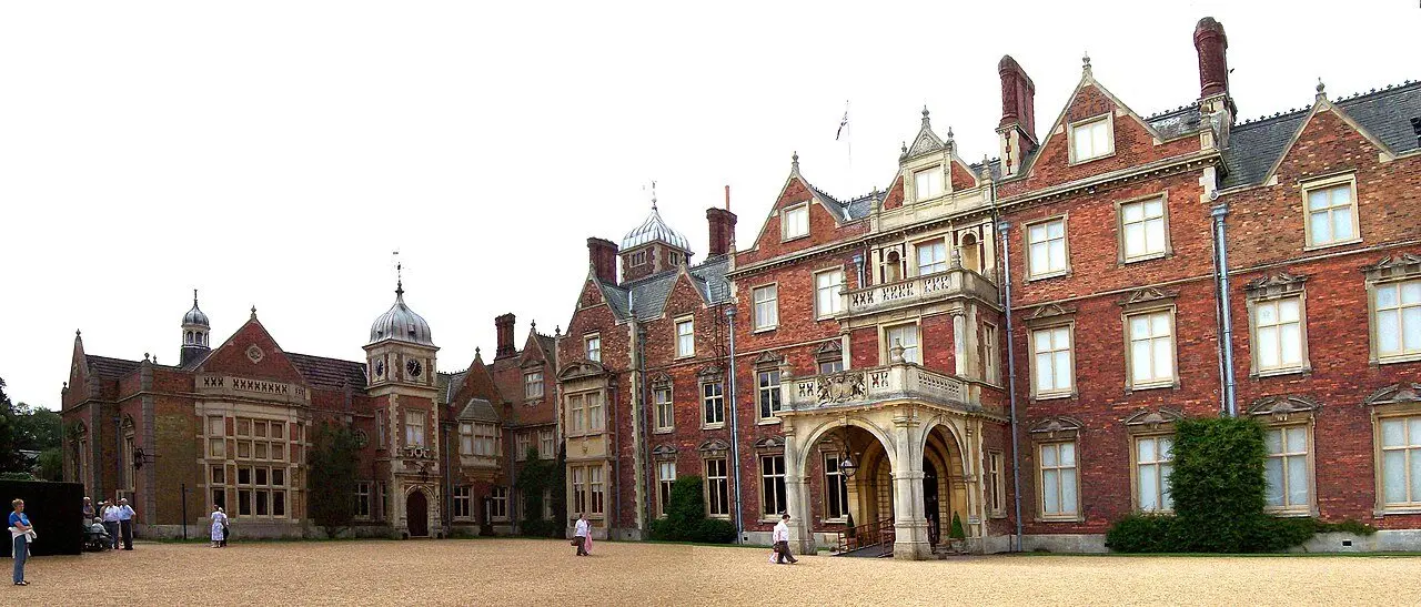 The red-brick entrance front of Sandringham House, Norfolk, on a sunny day