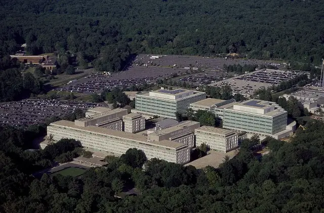 Aerial photograph of the CIA headquarters campus in Langley, Virginia, showing office buildings surrounded by trees