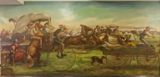 John Steuart Curry's mural of the 1889 Oklahoma Land Rush: settlers racing on horseback, in wagons, and on a high-wheel bicycle, beneath a wagon banner reading 'Oklahoma or Bust.'