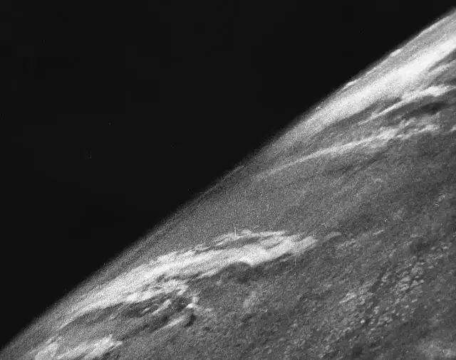 Black-and-white photograph of Earth's curved horizon against the blackness of space, taken from a V-2 rocket on October 24, 1946.