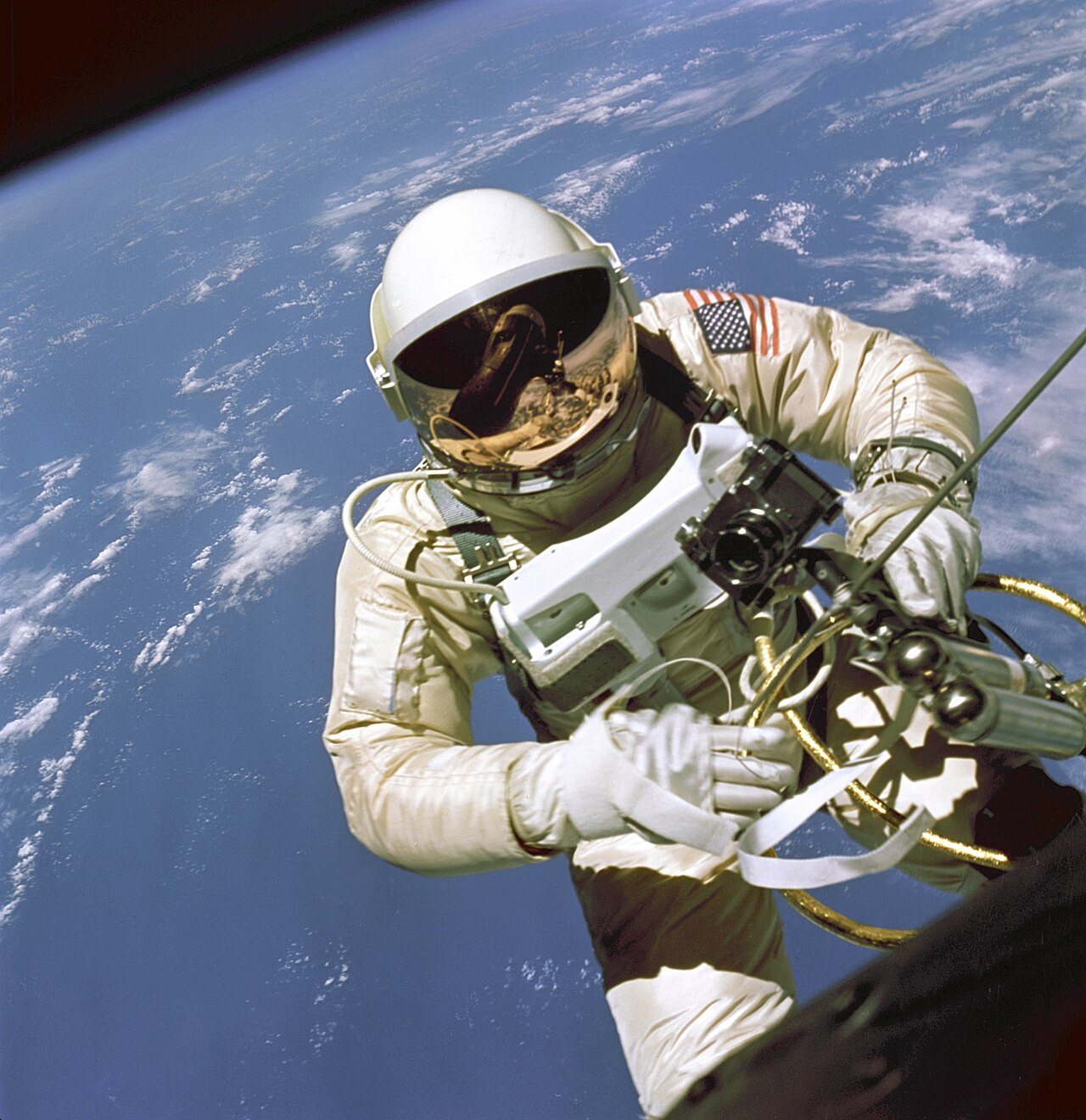 Astronaut Ed White floating outside the Gemini 4 capsule during the first American spacewalk on June 3, 1965, photographed by Jim McDivitt.