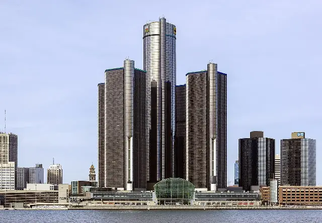 The General Motors Renaissance Center headquarters in Detroit, Michigan, a cluster of glass skyscrapers on the Detroit riverfront photographed from the south.