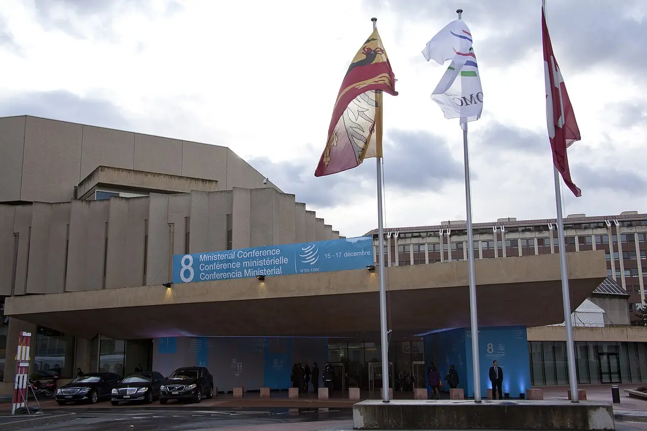 The CICG conference center in Geneva, site of a WTO ministerial conference, with WTO and Swiss flags flying outside.