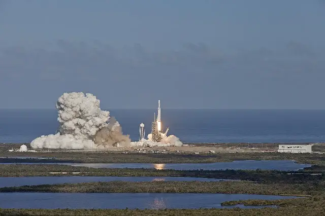 The Falcon Heavy rocket lifting off from Launch Complex 39A on February 6, 2018, with a huge plume of smoke