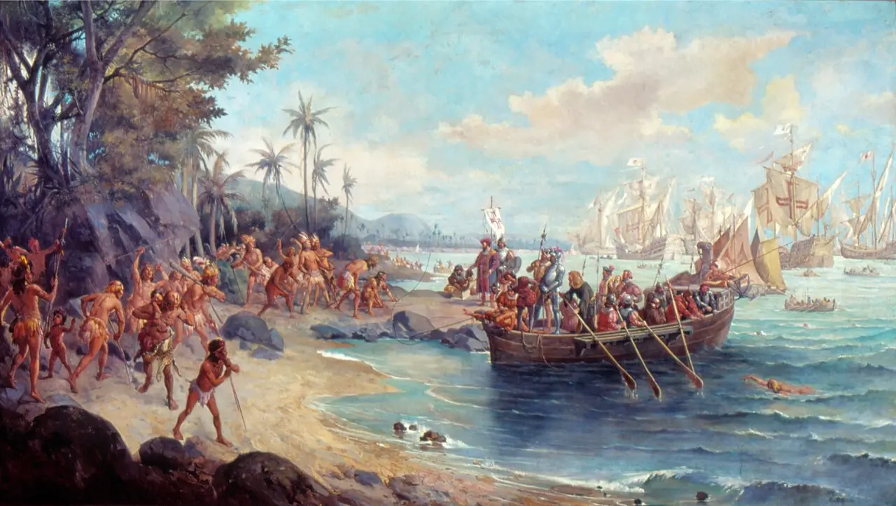 Oscar Pereira da Silva's 1902 painting of Pedro Álvares Cabral's landing at Porto Seguro: Portuguese caravels anchored offshore, a longboat of armored soldiers reaching the beach, and Indigenous people watching from the sand.