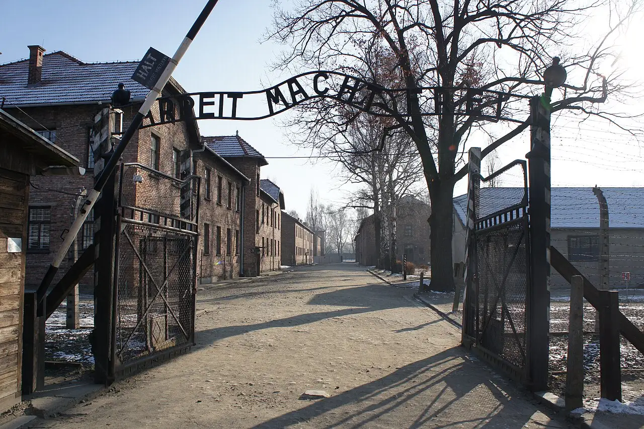 The main gate of the Auschwitz I camp with the 'Arbeit macht frei' inscription (modern photo).