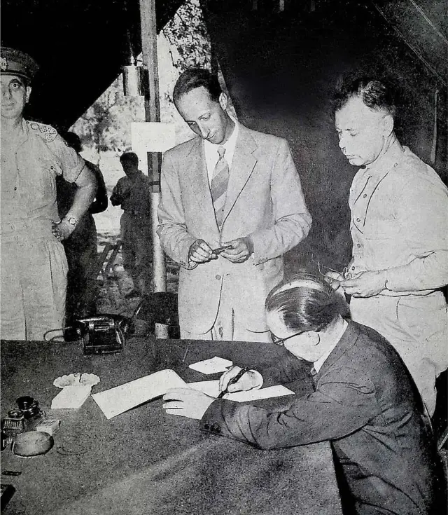 General Giuseppe Castellano signing the armistice at Cassibile on September 3, 1943, watched by General Walter Bedell Smith; the armistice was announced on September 8.