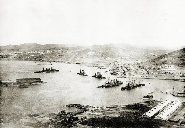A 1905 photograph of Port Arthur's harbor viewed from Gold Hill after the capitulation, with wrecked Russian warships in the bay.