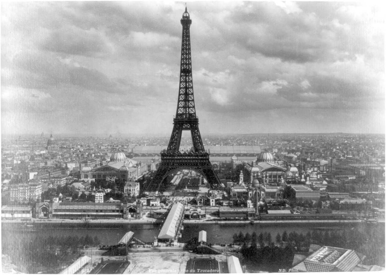 1889 photograph of the Eiffel Tower rising above the grounds of the Exposition Universelle in Paris.