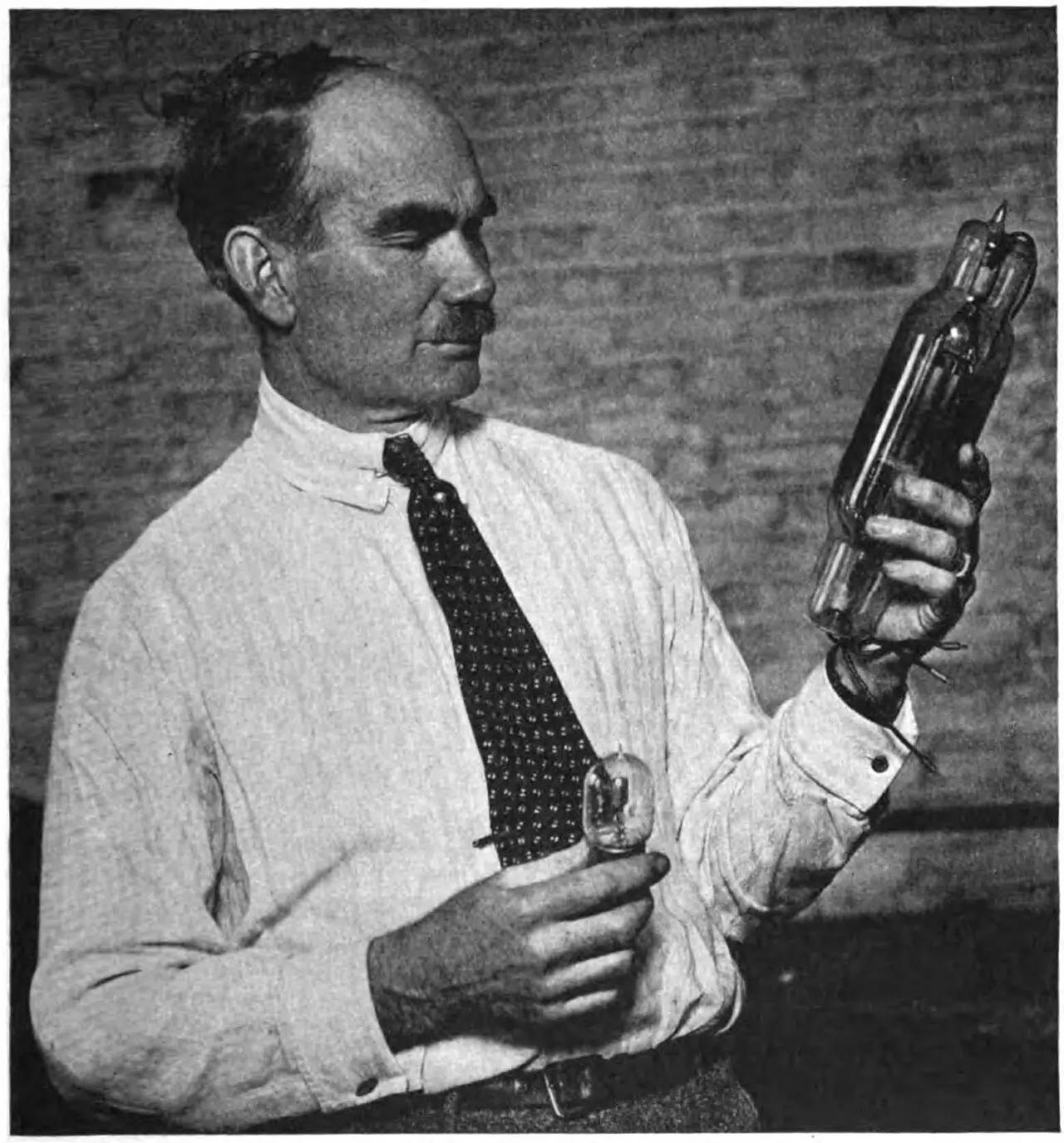 Inventor Lee de Forest holding Audion vacuum tubes, the devices that made radio amplification possible