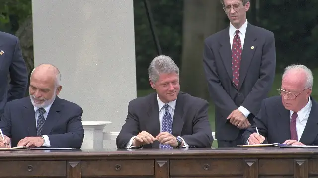 King Hussein of Jordan and Israeli Prime Minister Yitzhak Rabin sign the Washington Declaration on the White House lawn in July 1994 as President Bill Clinton watches.