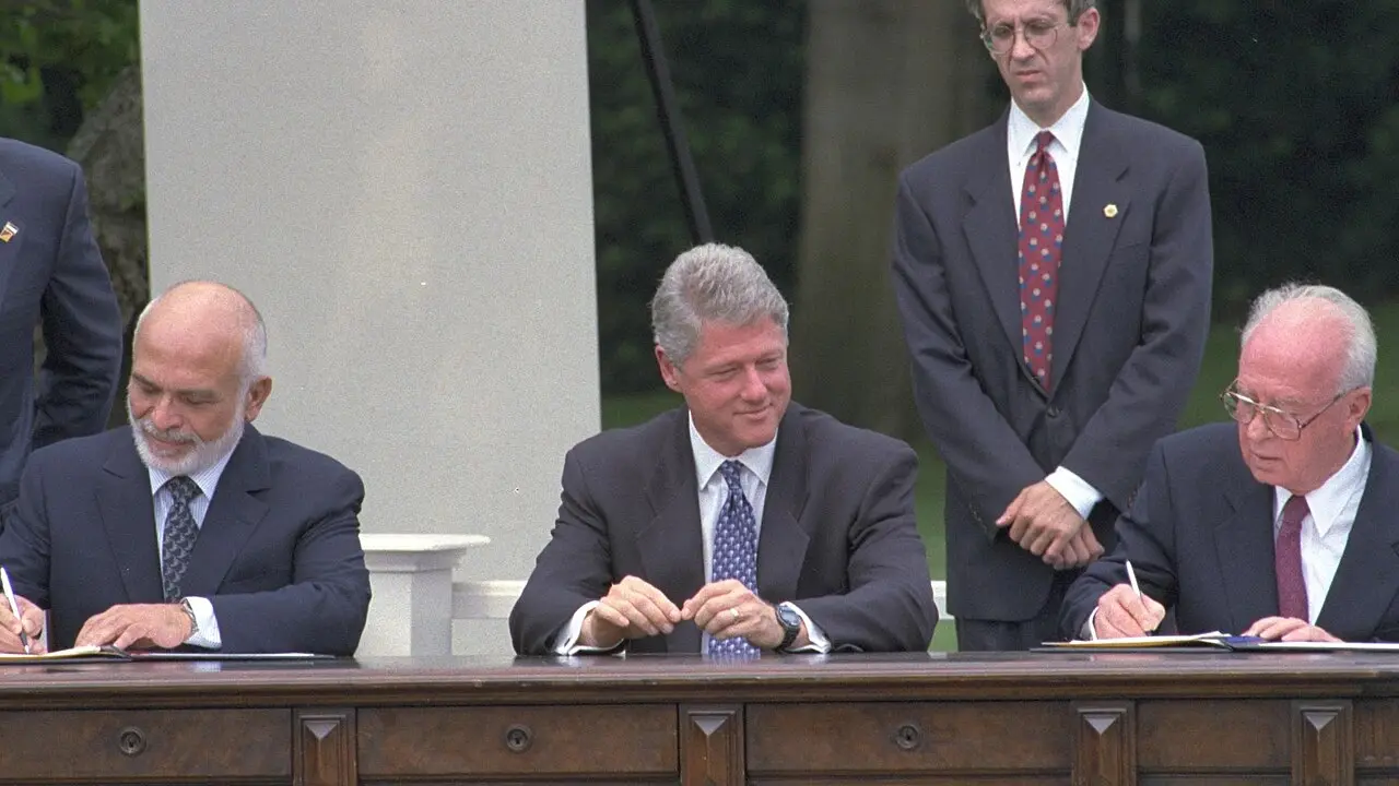 King Hussein of Jordan and Israeli Prime Minister Yitzhak Rabin sign the Washington Declaration on the White House lawn in July 1994 as President Bill Clinton watches.