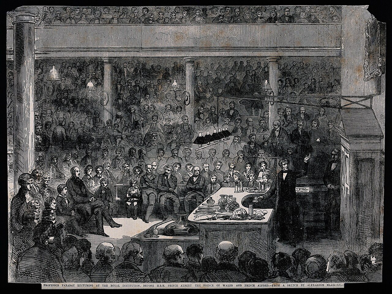 An 1856 engraving of Michael Faraday lecturing at the Royal Institution in London, with Prince Albert, the Prince of Wales, and Prince Alfred in the audience.