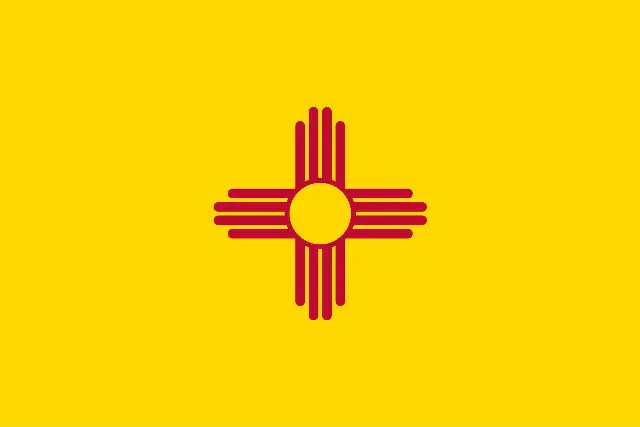 The flag of New Mexico: a red Zia sun symbol centered on a field of yellow.