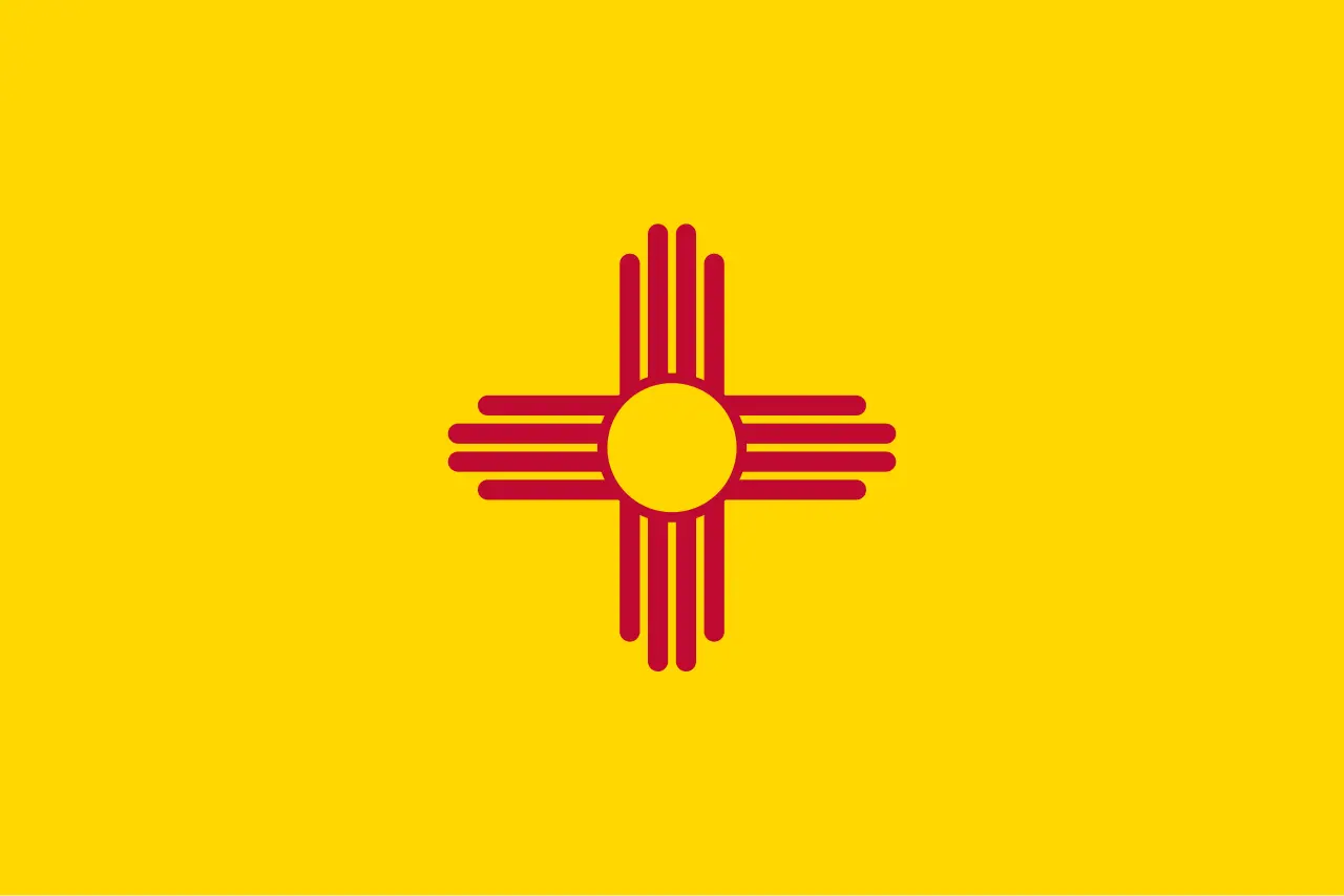 The flag of New Mexico: a red Zia sun symbol centered on a field of yellow.