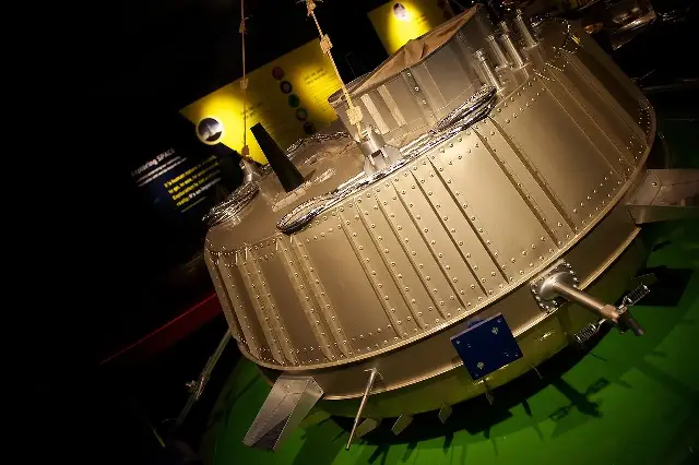 Full-scale model of the Huygens probe, a squat riveted metal capsule, on display at a space exhibition