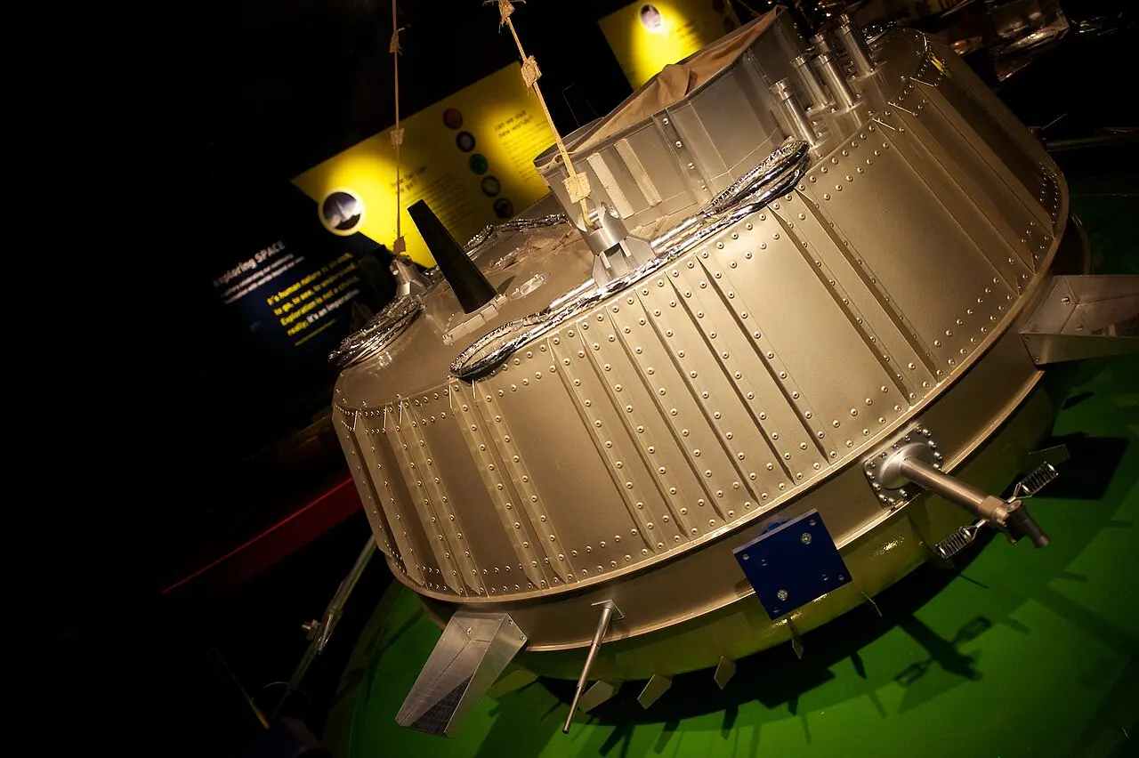 Full-scale model of the Huygens probe, a squat riveted metal capsule, on display at a space exhibition