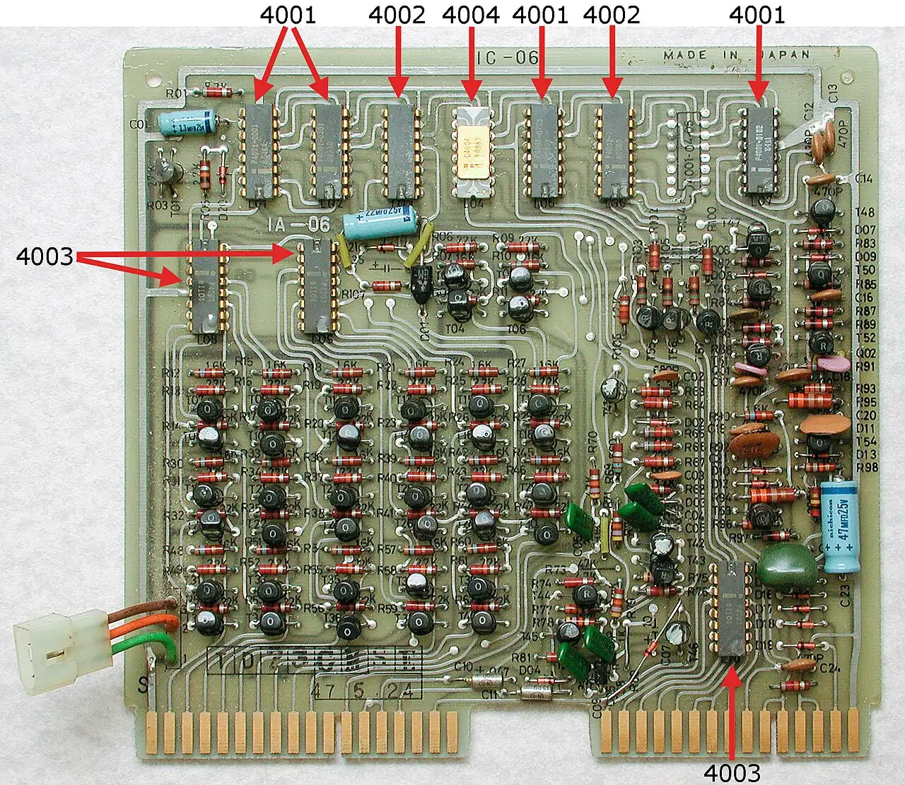 An Intel 4004 microprocessor mounted on a Busicom calculator circuit board, with the 4004 chip labeled among the board's components