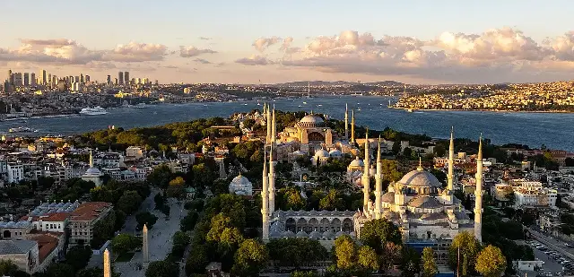 Aerial view of Istanbul's historic peninsula with its mosques and the modern skyline beyond.