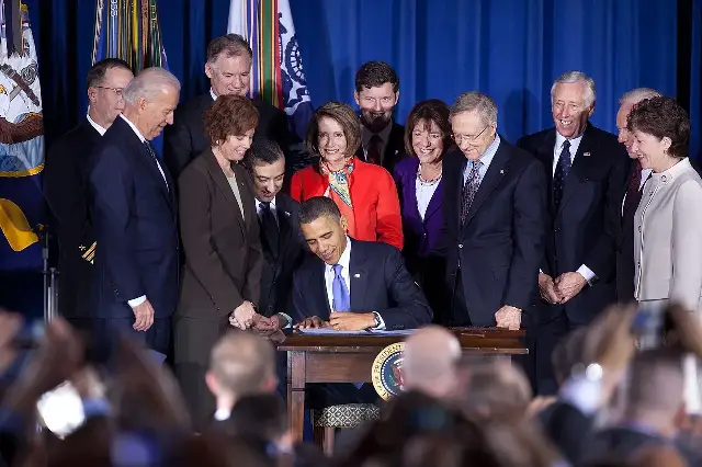President Barack Obama signing the Don't Ask, Don't Tell repeal act on December 22, 2010, surrounded by officials and veterans